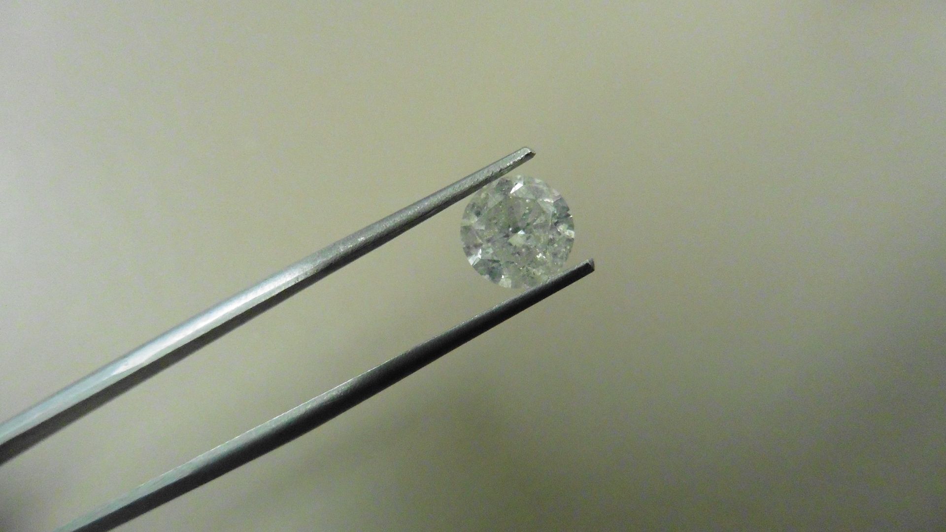 1.73ct Brilliant Cut Diamond, Enhanced stone. G/H colour, I1-2 clarity. 7.32 x 4.77mm. Valued at £