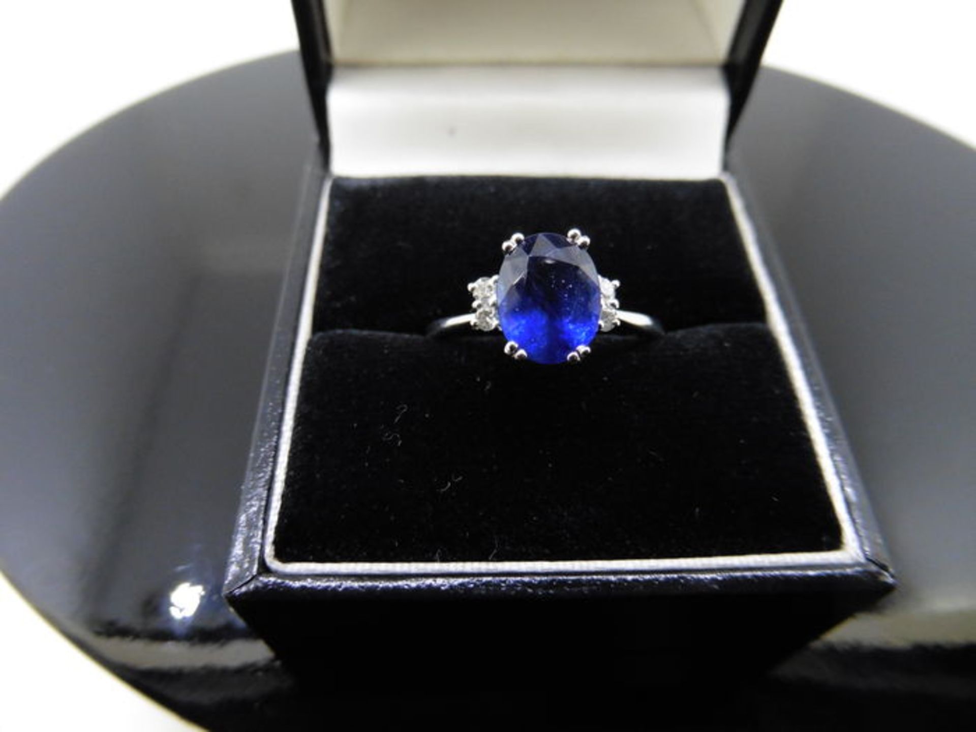 2.40ct sapphire and diamond ring. Oval cut ( glass filled ) sapphire with 2 small brilliant cut