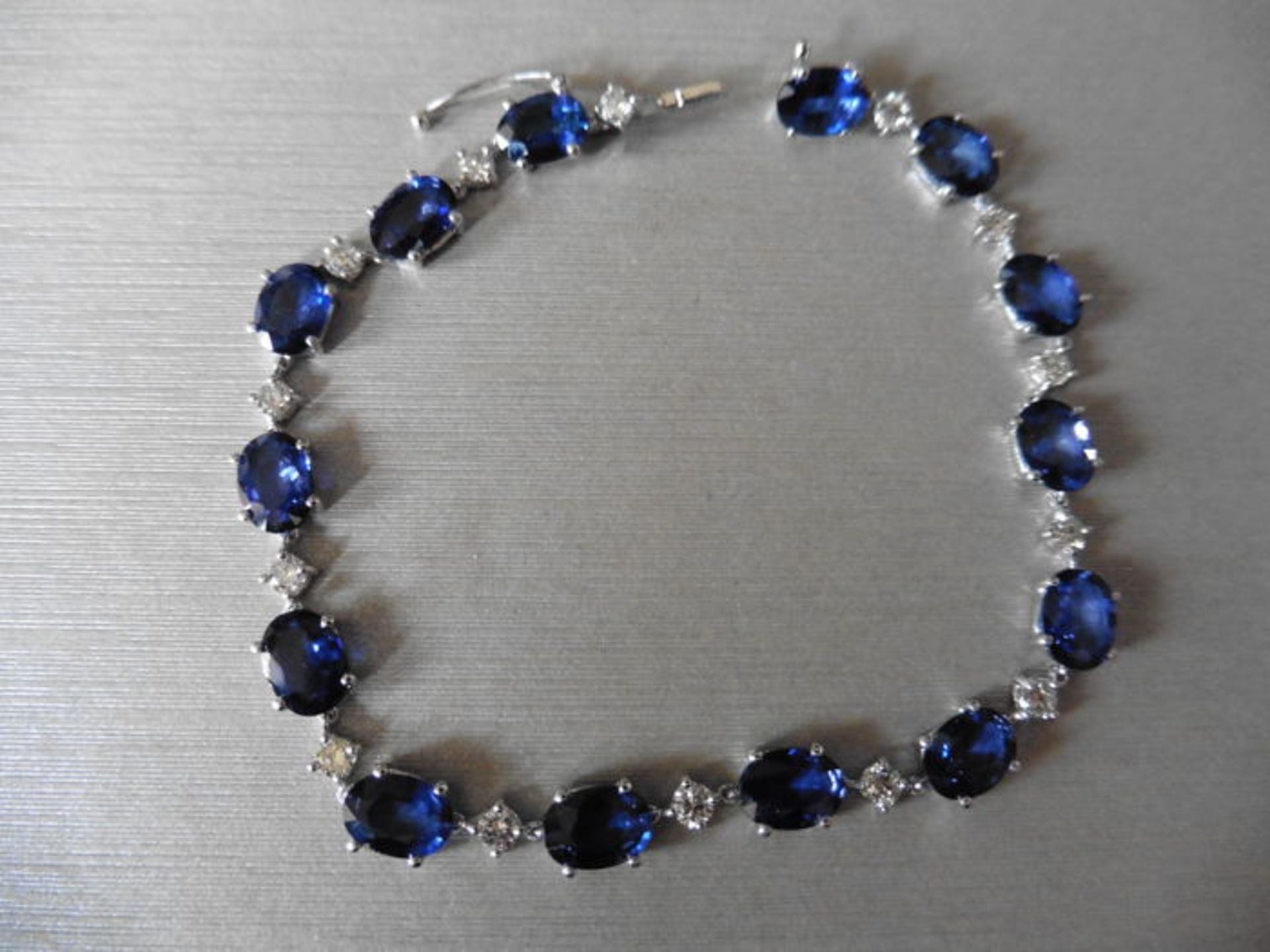 11ct sapphire and diamond bracelet.Set with oval ( treated ) sapphires and small brilliant cut