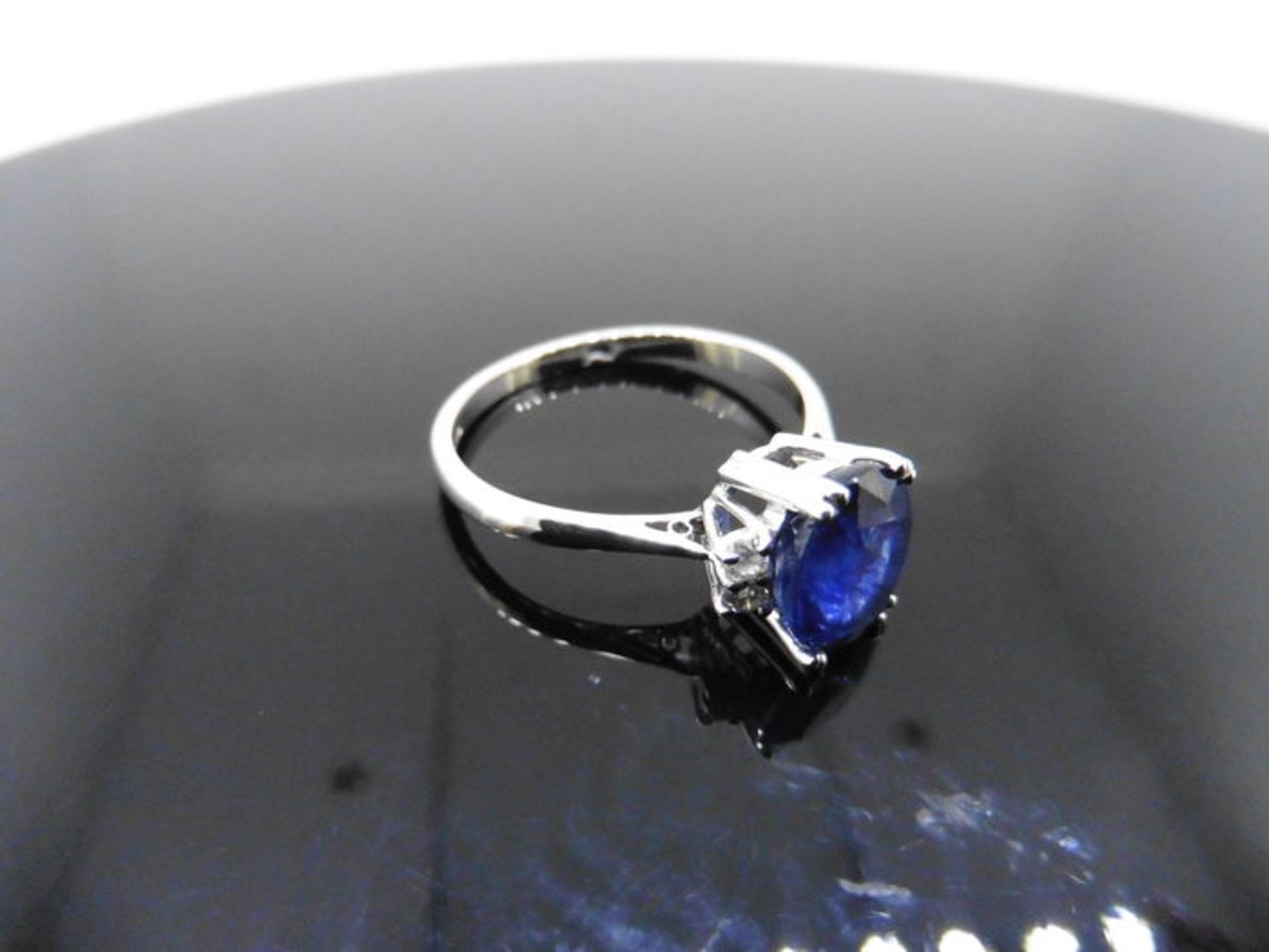 2.40ct sapphire and diamond ring. Oval cut ( glass filled ) sapphire with 2 small brilliant cut - Image 3 of 5