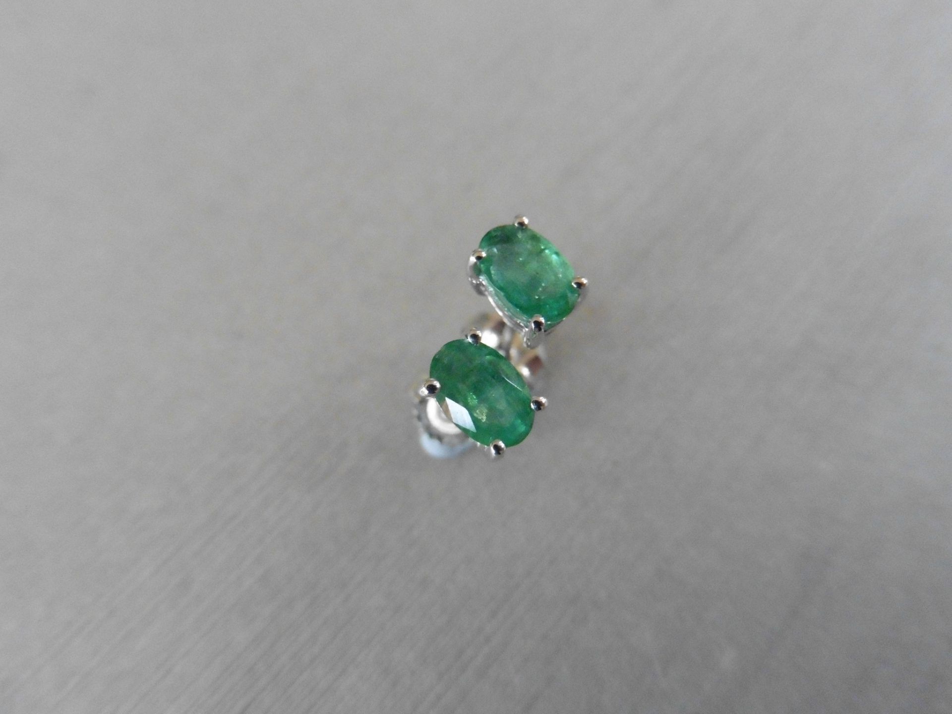 0.60ct emerald stud style earrings set in 9ct white gold. 6 x 4mm oval cut emeralds ( treated) set