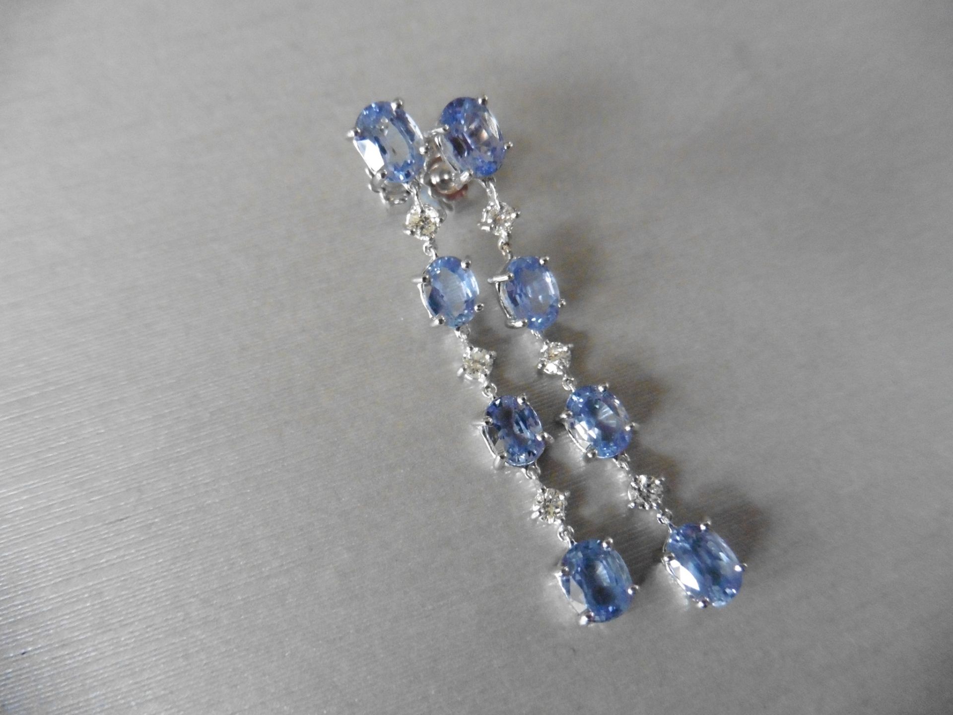 6ct ceylon sapphire and diamond drop earrings. Each set with 4 oval cut sapphires and 3 brilliant