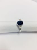 2.40ct Sapphire and diamond dress ring. Oval cut ( glass filled ) sapphire with 3 small brilliant