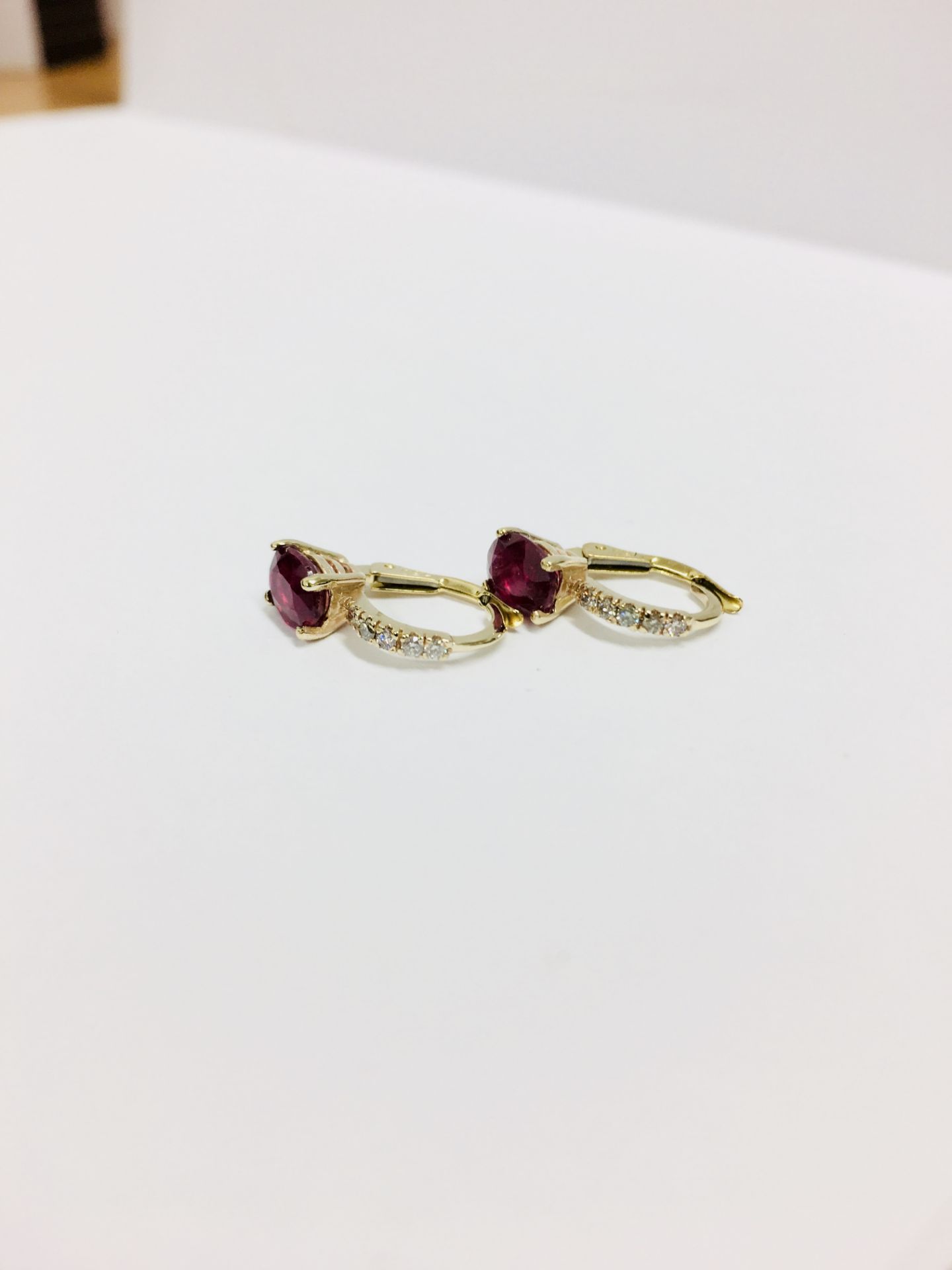 1.60ct Ruby and diamond hoop style earrings. Each is set with a 7x 5mm oval cut Ruby ( treated ) - Image 2 of 3