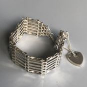 A retro silver gate bracelet with heart padlock and safety chain - London hallmarks