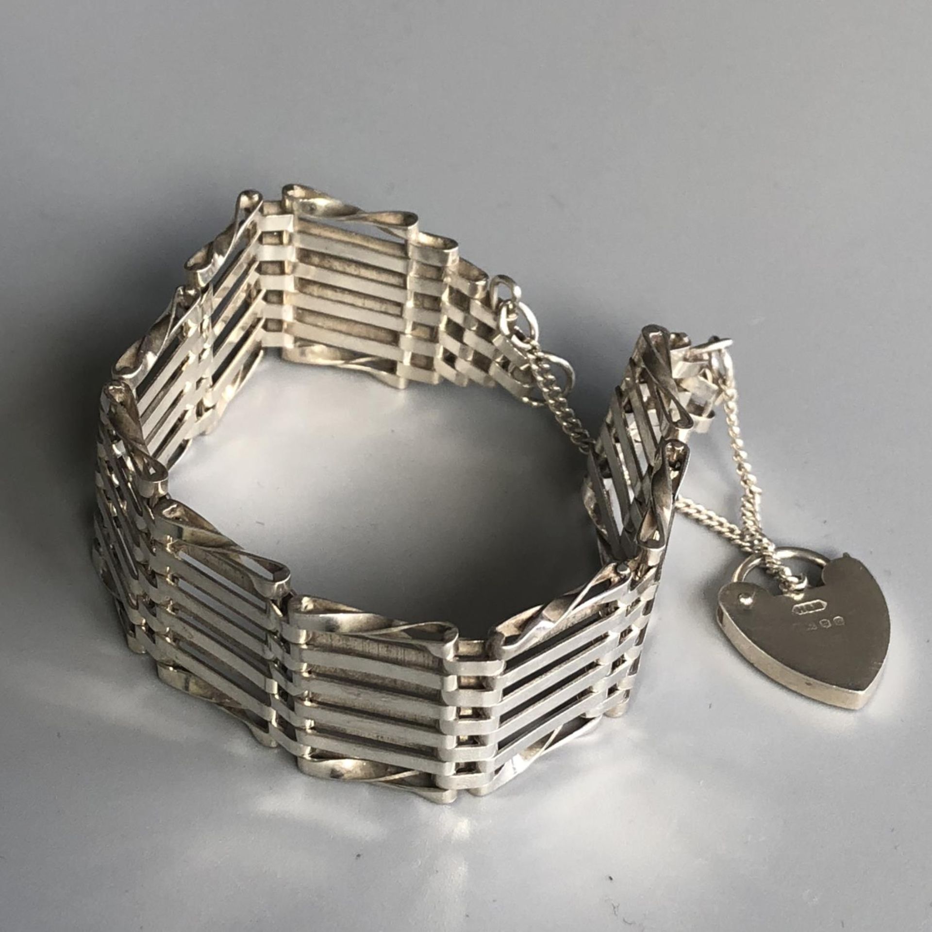 A retro silver gate bracelet with heart padlock and safety chain - London hallmarks