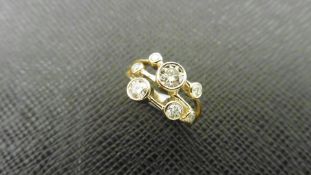 1.00ct 9ct yellow gold diamond dress ring, rain dance style. Set with 7 graduated brilliant cut