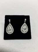 2.04ct diamond drop earrings. Each set with a certificated pear shaped diamond with a halo