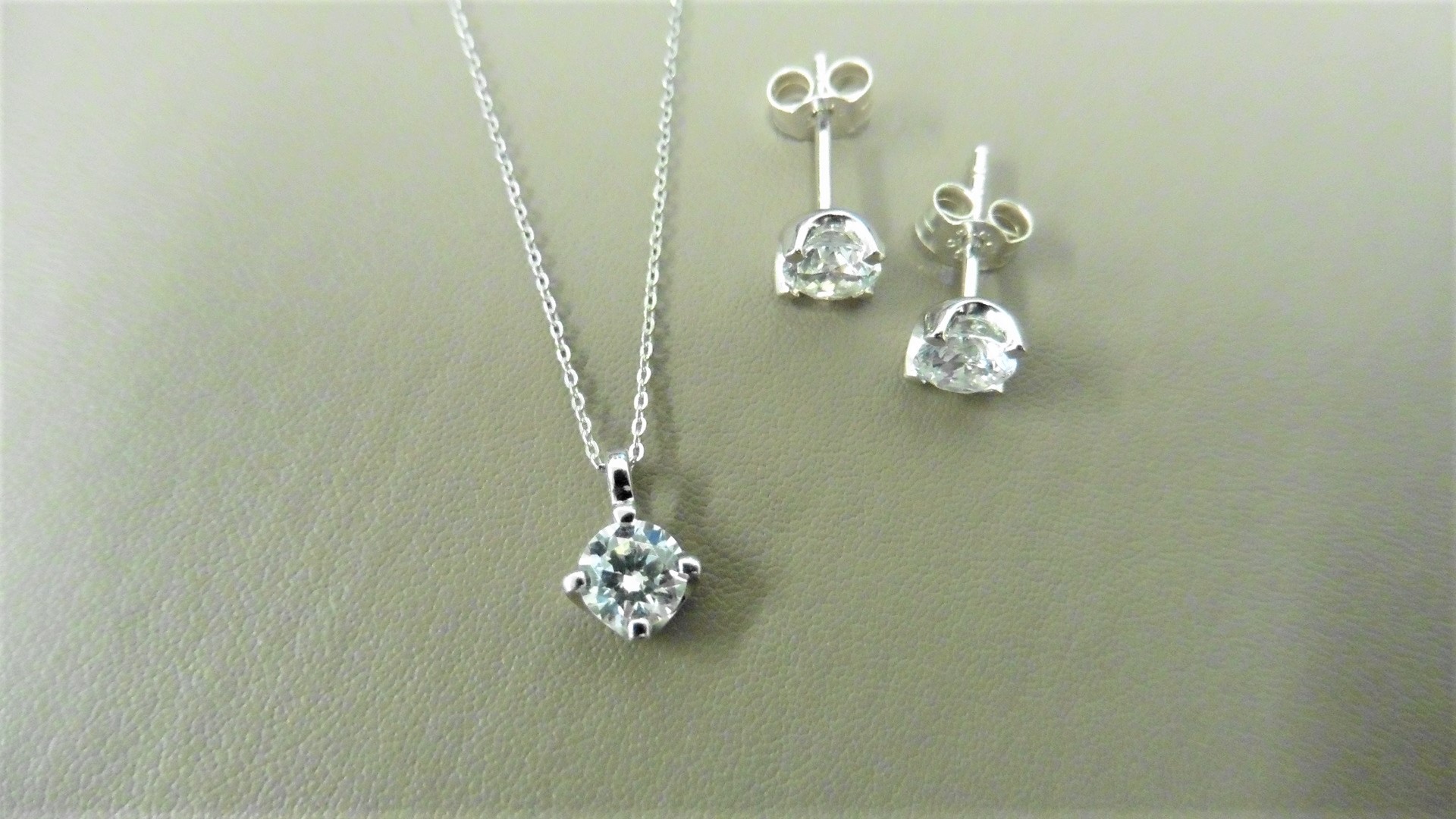 0.25ct / 0.50ct diamond pendant and earring set in platinum. Pendant - 0.25ct brilliant cut diamond,