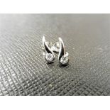 0.20ct diamond swirl style earrings set in platinum 950. 2 small brilliant cut diamonds, H/I