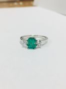 Emerald and diamond trilogy style ring. Rectangular cut emerald ( treated ) 0.70ct with a