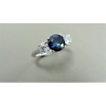 Sapphire and diamond trilogy ring. 5mm round cut sapphire ( treated ) with a brilliant cut diamond