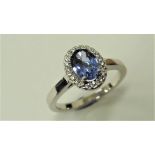 Tanzanite and Diamond cluster ring set in platinum. Oval cut tanzanite ( treated ) 1ct, surrounded