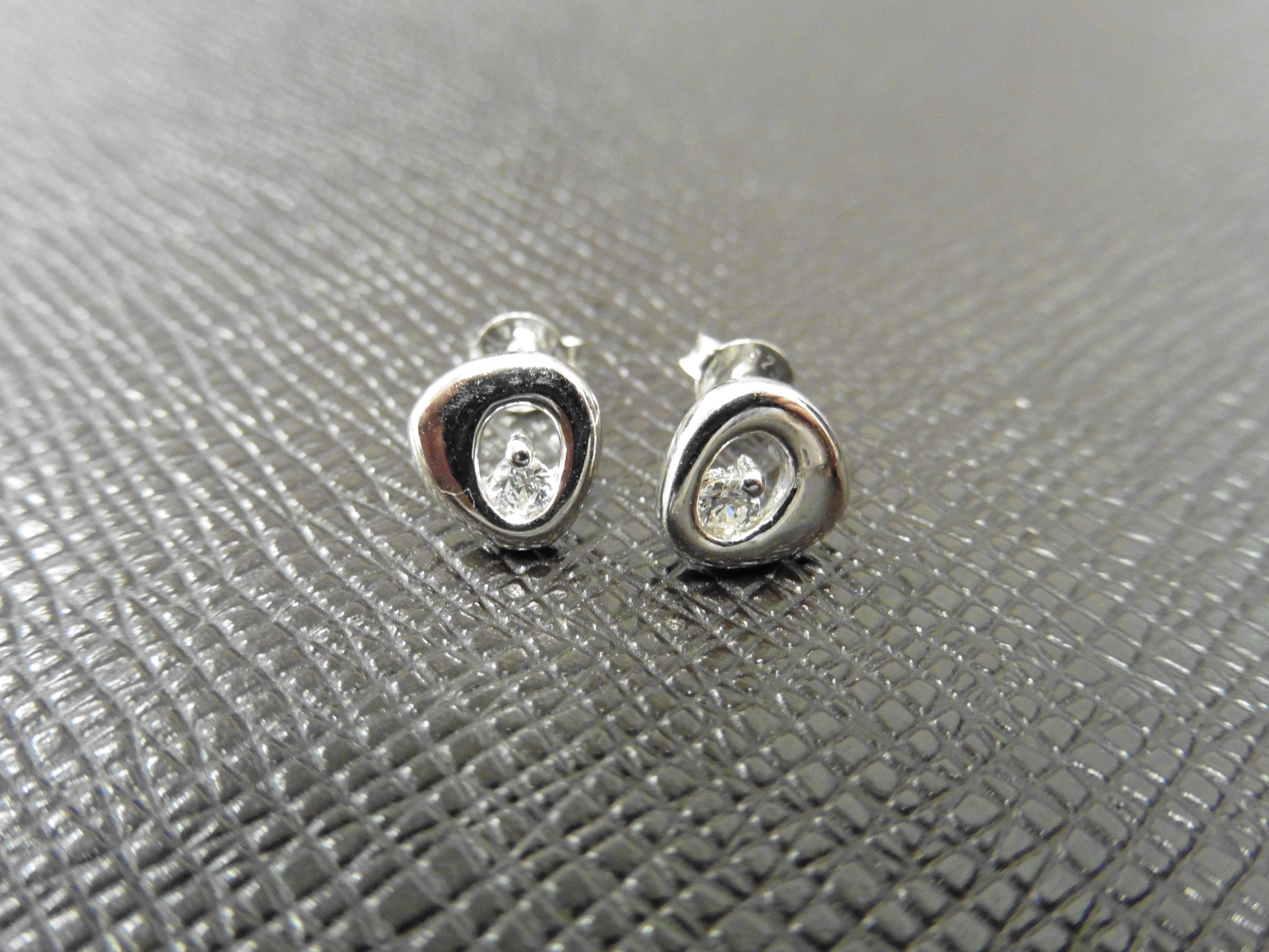 0.12ct diamond earrings set in platinum 950. 2 small brilliant cut diamonds, H/I colourand si2
