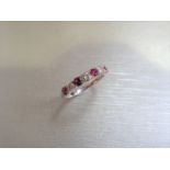 Ruby and diamond eternity band ring set in platinum. 4 round cut ( treated ) rubies and 3