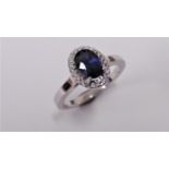 Sapphire and Diamond cluster ring set in platinum. Oval cut sapphire ( fracture filled ) 1ct,