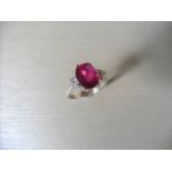 Ruby and diamond dress ring set in platinum. Oval cut ruby ( fracture filled ) 2.40ct approx with