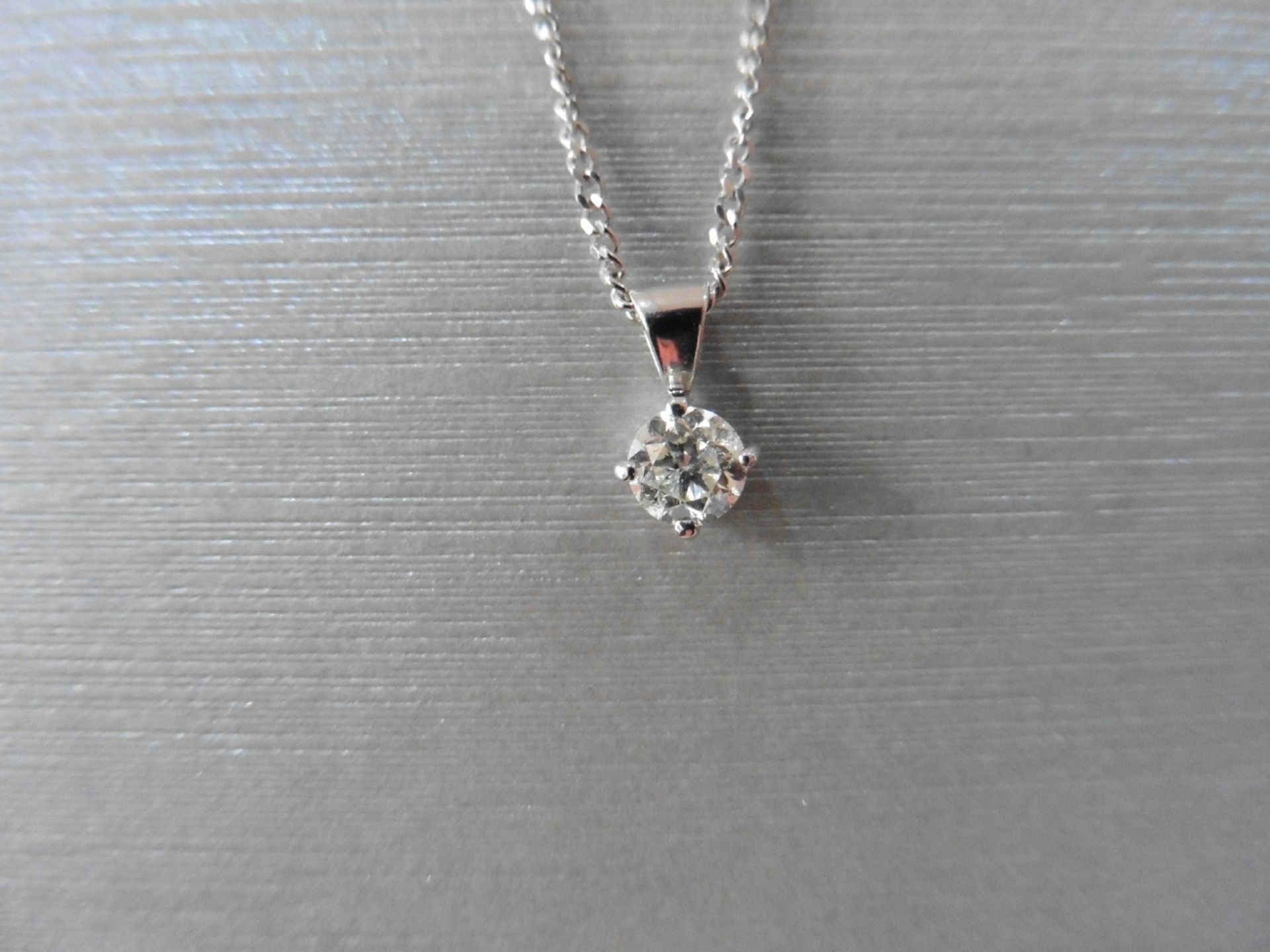 0.40ct diamond solitaire pendant set in 18ct gold. Off set 4 claw setting,plain bale. I colour and
