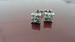 0.80ct diamond cluster style stud earrings. Each set with 4 small brillint cut diamonds, I colour