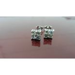 0.80ct diamond cluster style stud earrings. Each set with 4 small brillint cut diamonds, I colour