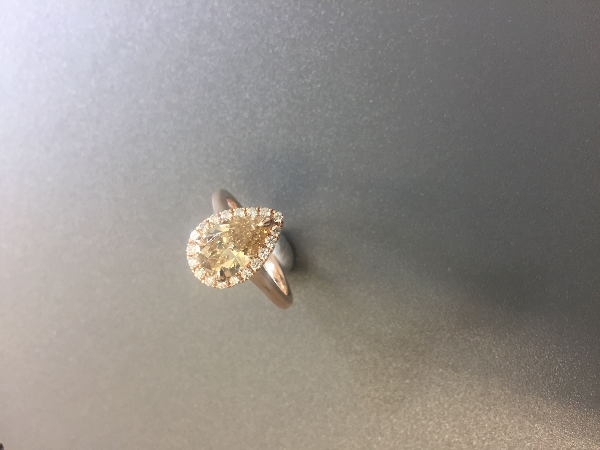 1.47ct pear shaped diamond set ring. Fancy yellow pear diamond, I1 clarity. Set in 18ct rose gold.