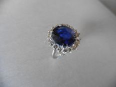 8.50ct sapphire and diamond cluster dress ring set in platinum. Oval cut sapphire ( fracture