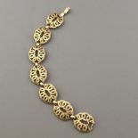 Vintage mid-century bracelet by TRIFARI textured gold tone swirl oval design