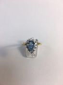 18ct yellow gold blue topaz and diamond halo ring