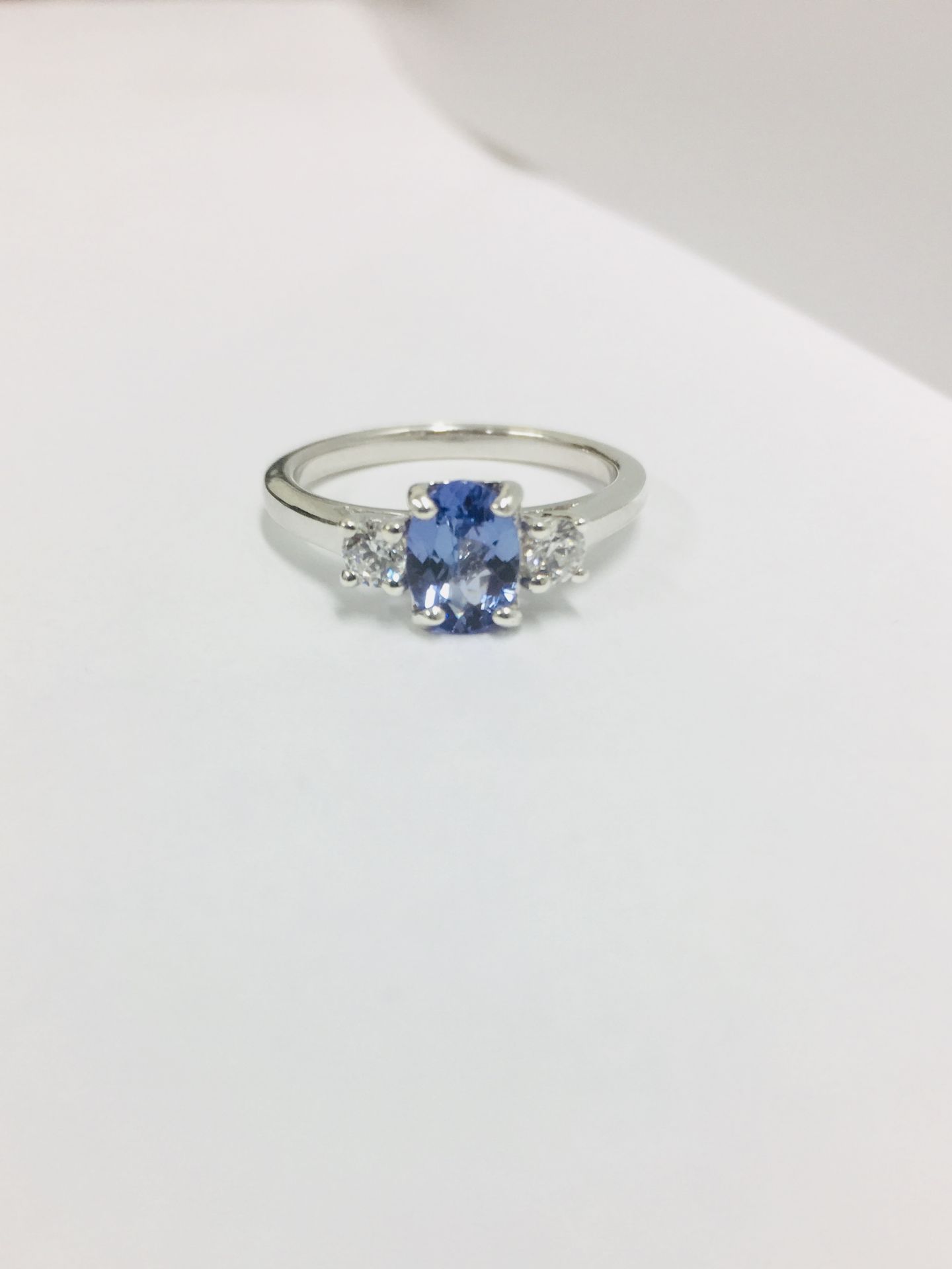 Tanzanite and diamond trilogy ring. 1ct, 7 x 5mm oval tanzanite ( treated ) with a brilliant cut