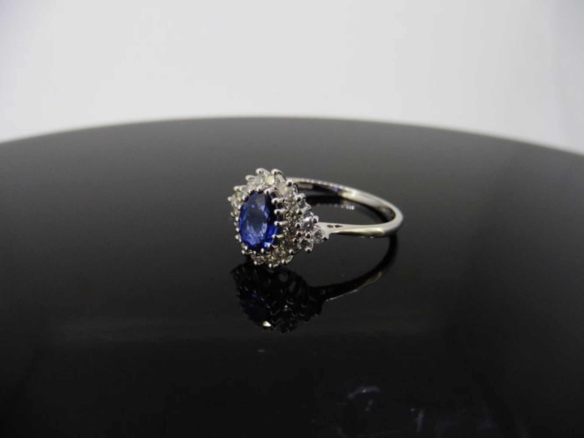 Sapphire and diamond cluster style ring set in platinum. Oval cut ( treated ) sapphire 1ct with 0. - Image 2 of 3