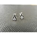 0.10ct diamond tear drop earrings set in platinum 950. 2 small brilliant cut diamonds, H colourand