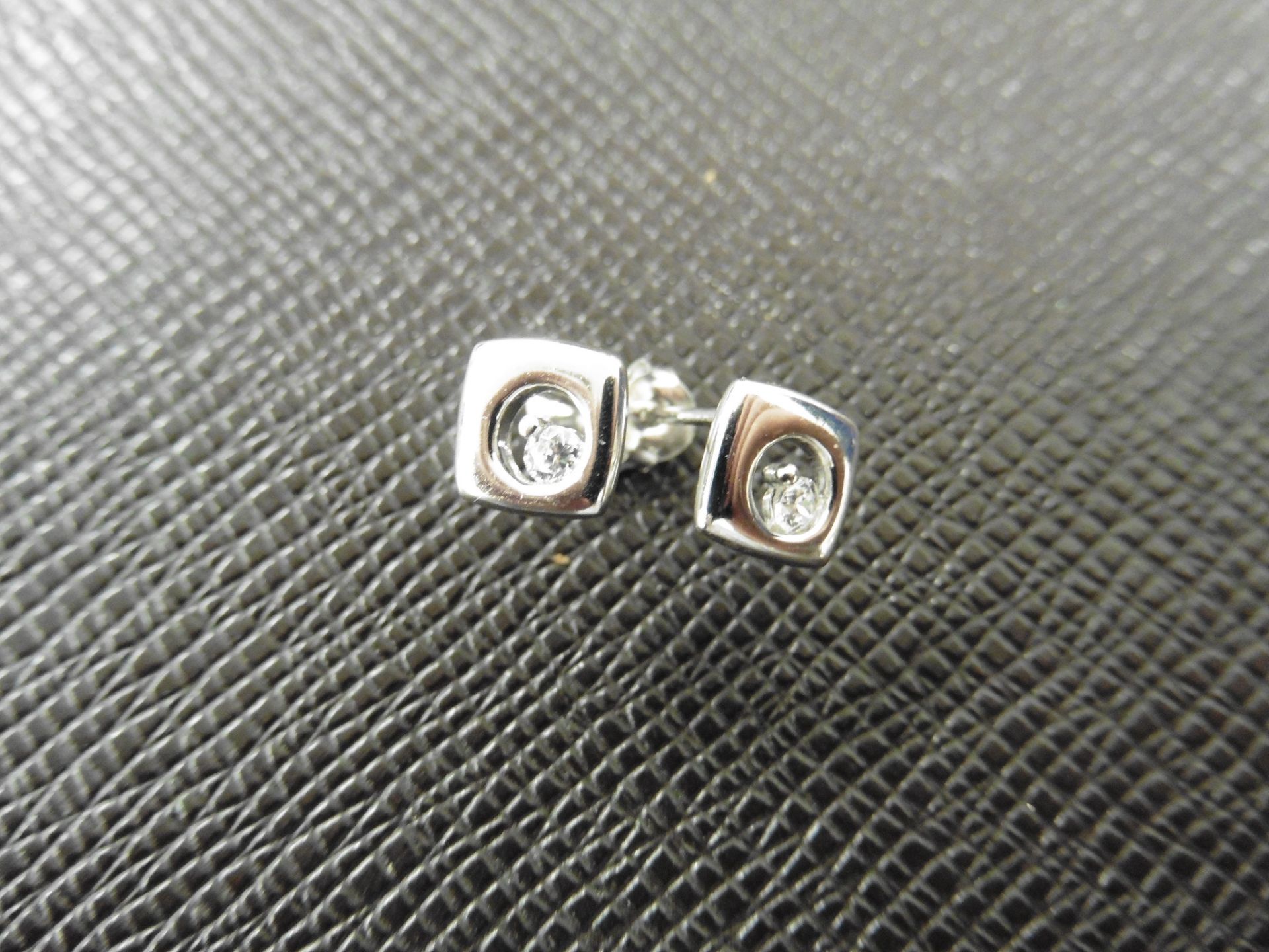 0.10ct diamond earrings set in platinum 950. 2 small brilliant cut diamonds, H colourand si2