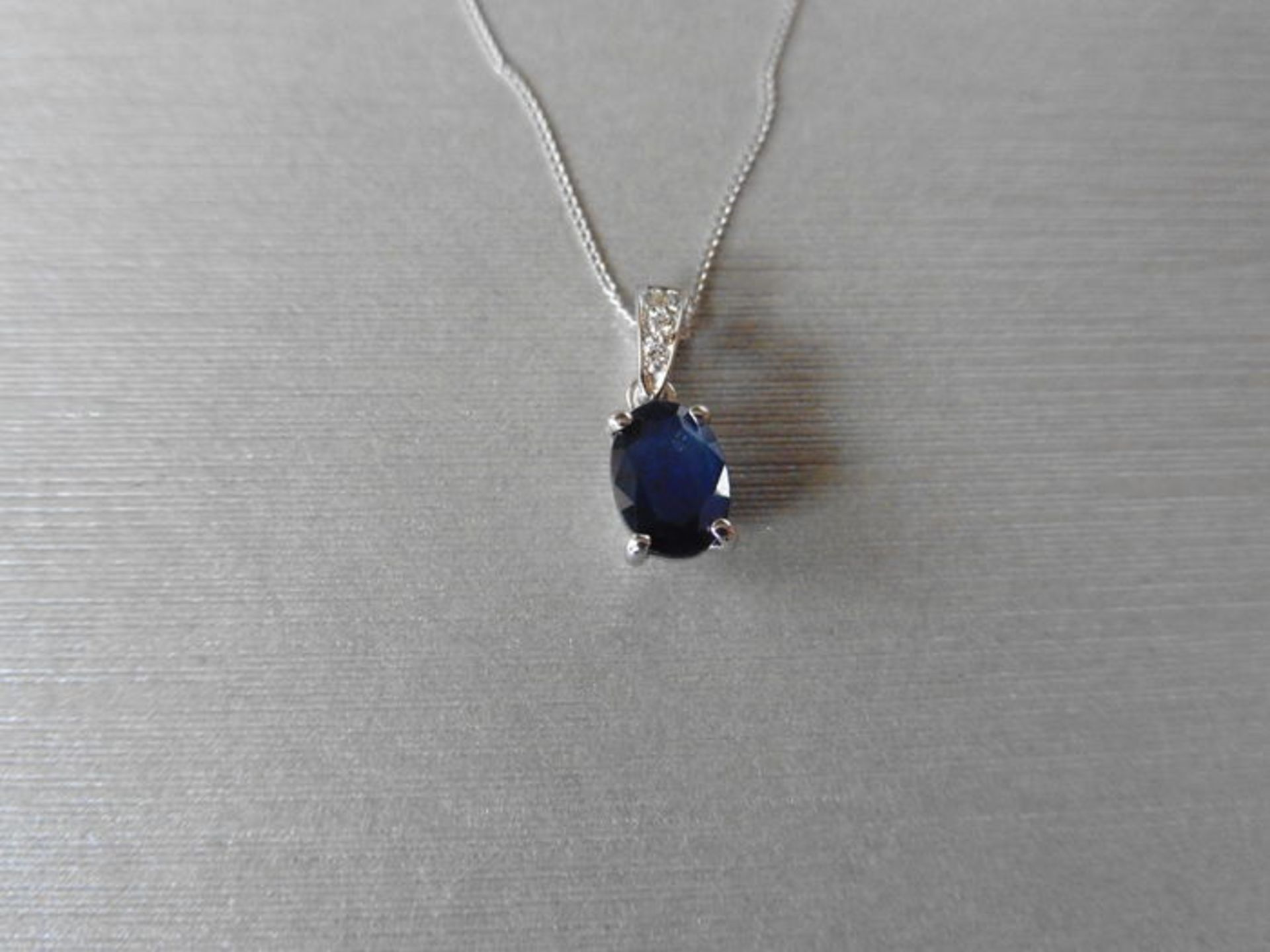 1ct sapphire and diamond pendant with an 7x5mm oval cut sapphire ( fracture treated ) and a