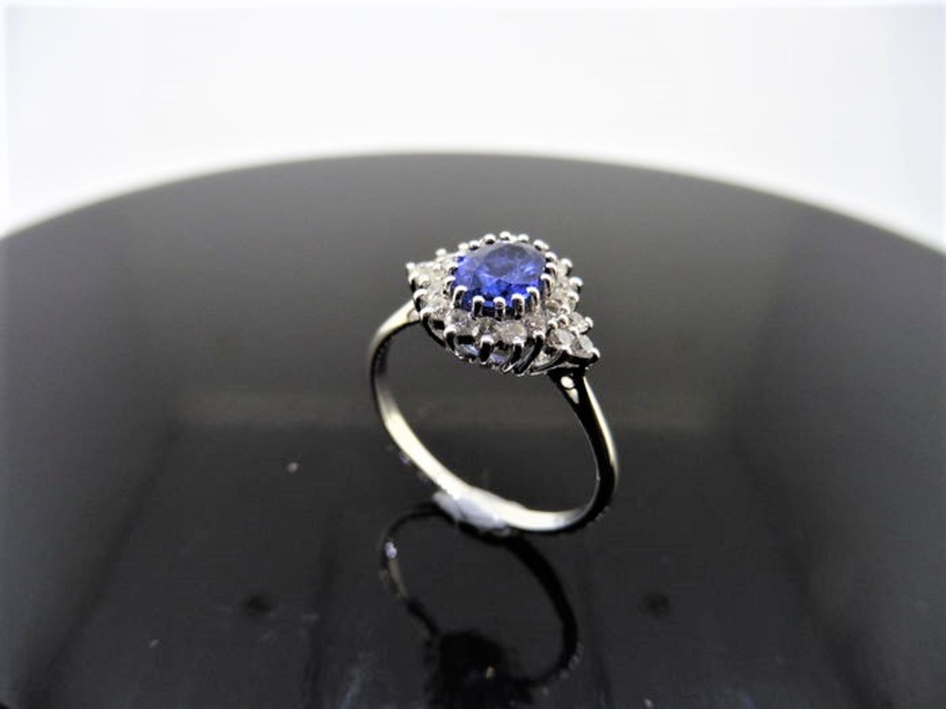 Sapphire and diamond cluster style ring set in platinum. Oval cut ( treated ) sapphire 1ct with 0. - Image 3 of 3