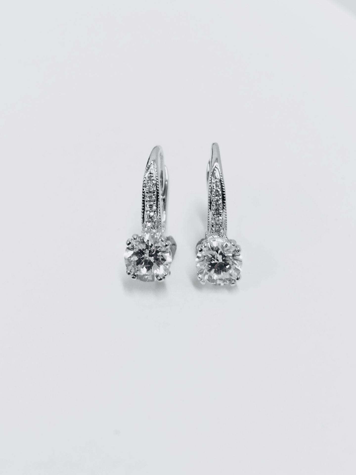 18ct white gold hoop style earrings with hinge fastners. 2 x 0.50ct Brilliant cut diamonds, i colour