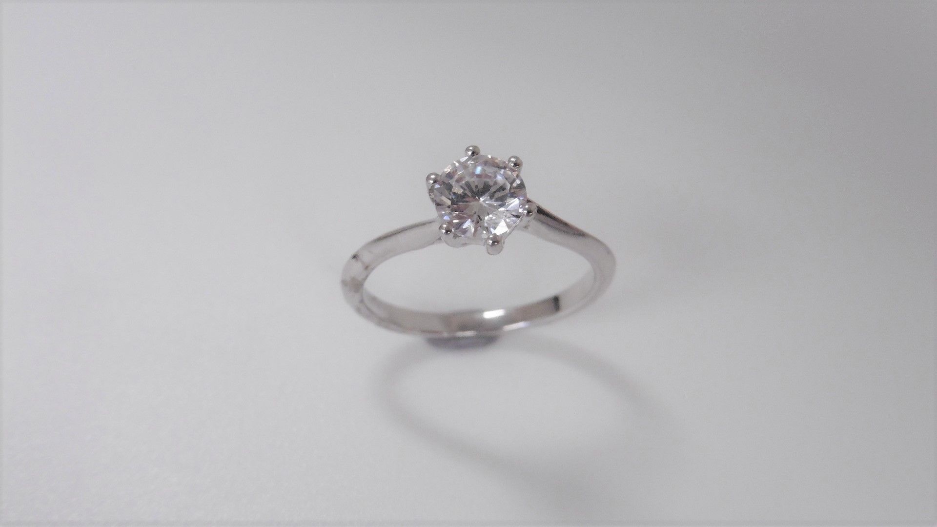 1.02 ct diamond twist solitaire ring set in platinum. 6 claw setting. Enhanced brilliant cut