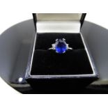 2.40ct sapphire and diamond ring. Oval cut ( glass filled ) sapphire with 2 small brilliant cut