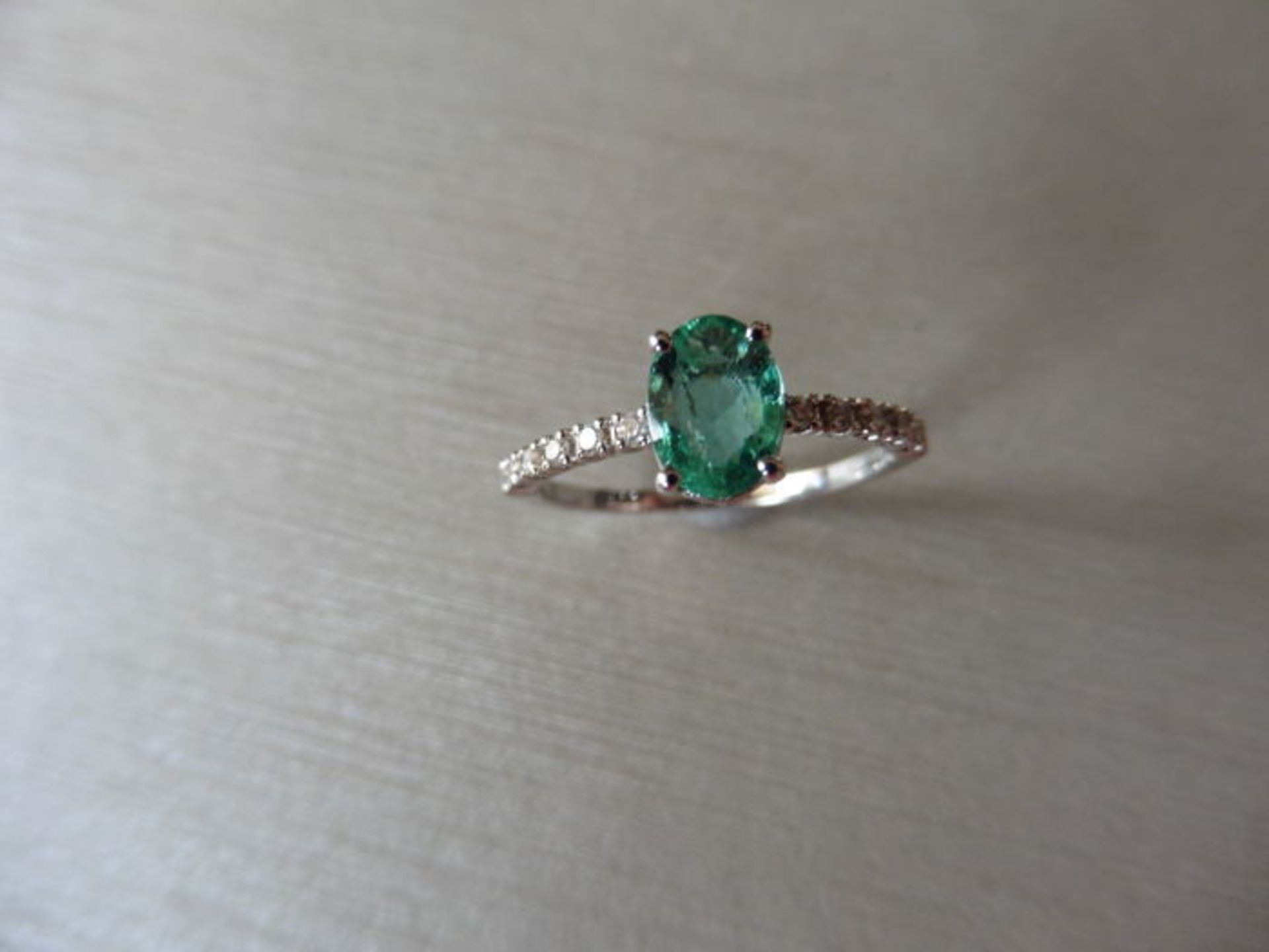 0.80ct / 0.12ct Emerald and diamond dress ring. Oval cut ( oil treated) emerald with small