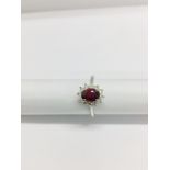 0.80ct Ruby and diamond cluster ring set with a oval cut(glass filled) ruby which is surrounded by