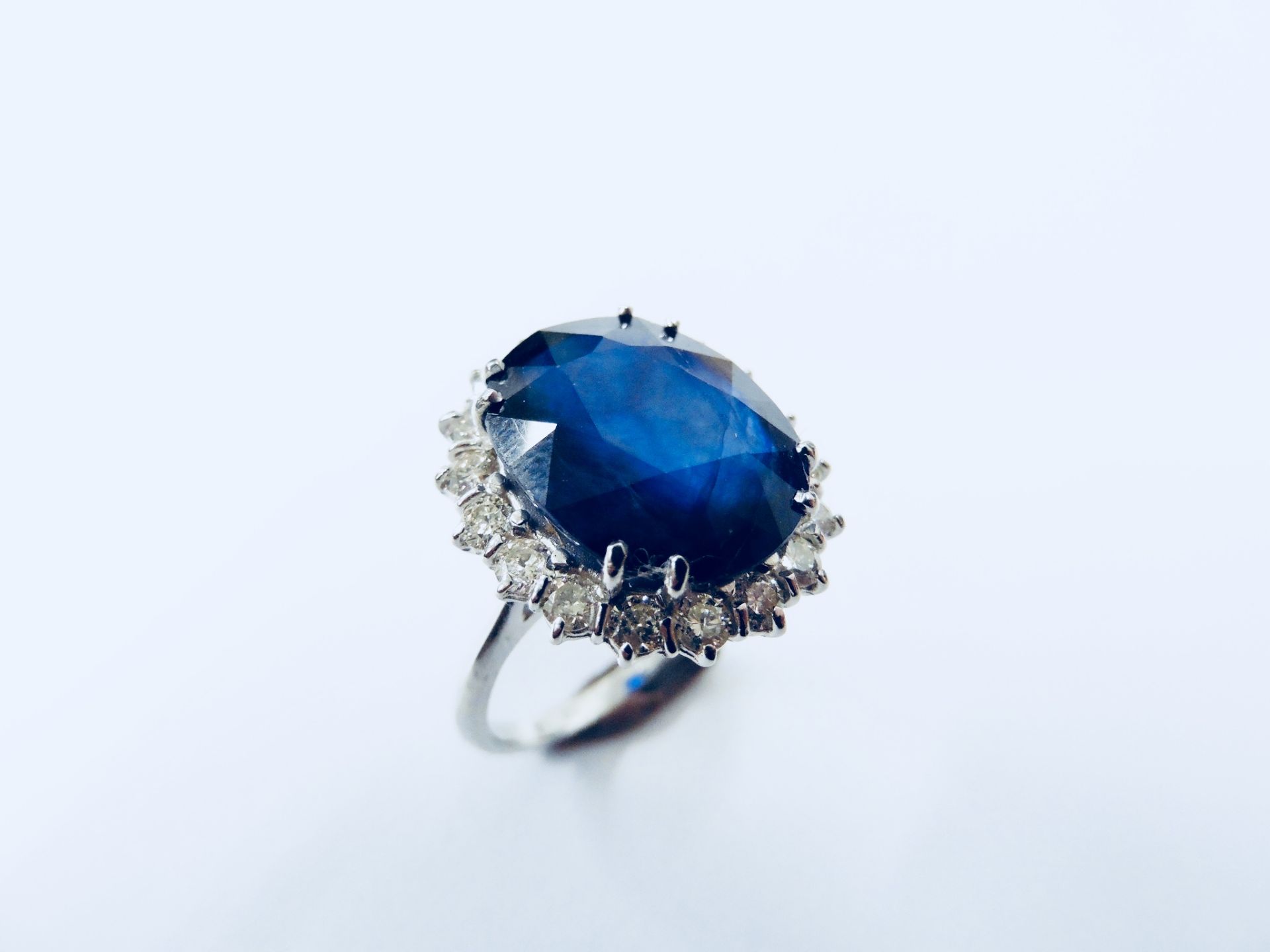 10ct sapphire and diamond cluster ring. Oval cut colour treated ( glass filled ) sapphire surrounded - Image 2 of 5