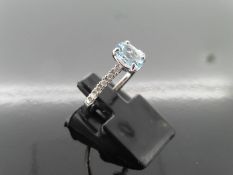 0.80ct / 0.12ct Aqua marine and diamond dress ring. Oval cut Aqua with small diamonds set into the