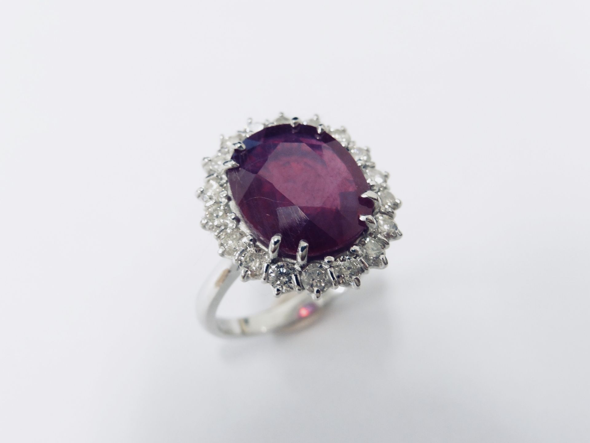 10ct ruby and diamond cluster ring. Oval cut ruby( glass filled) in the centre surrounded by