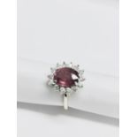 2.50ct Ruby and diamond cluster ring set with an oval cut ( glass filled )ruby which is surrounded