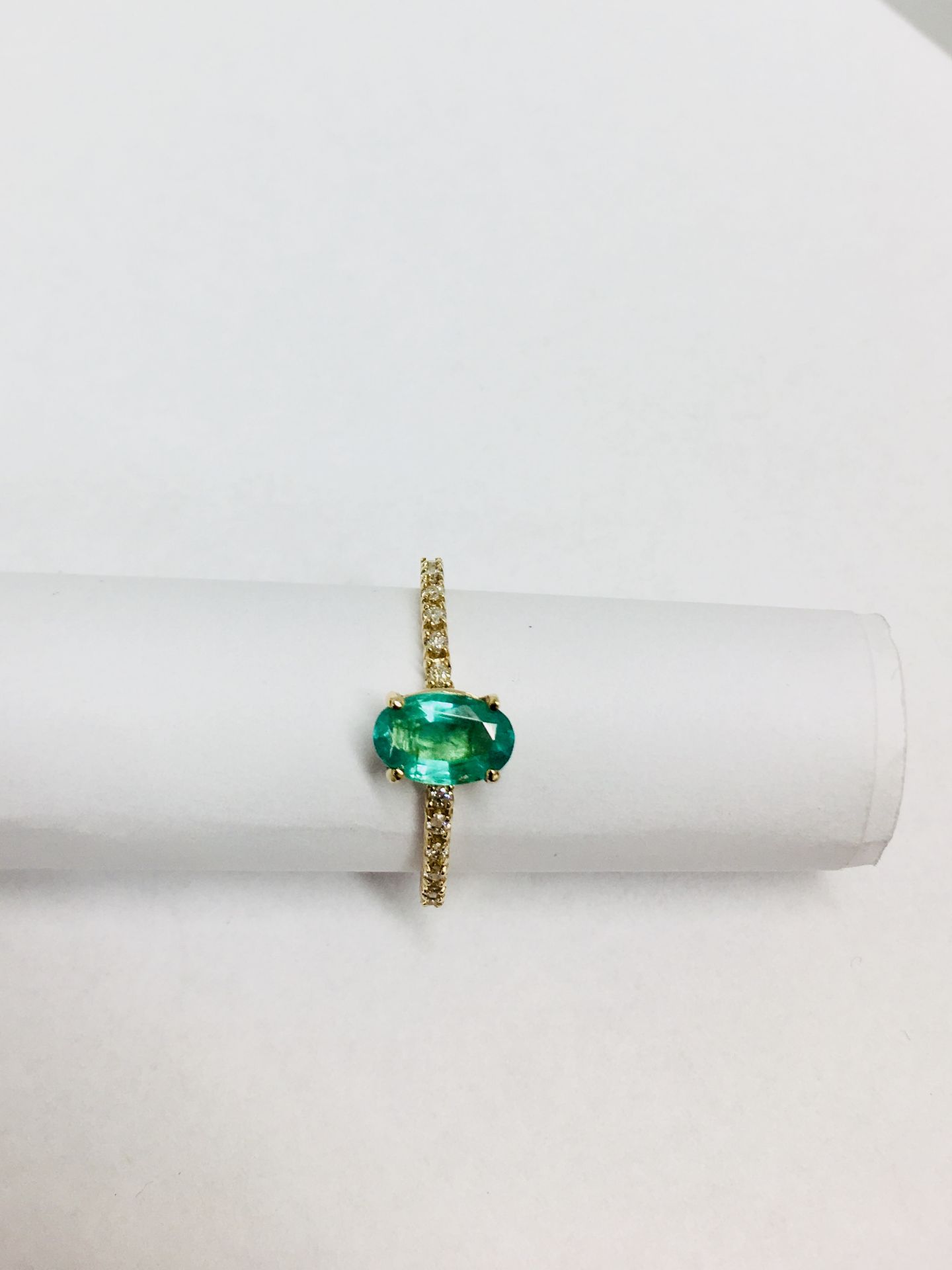 0.80ct / 0.12ct Emerald and diamond dress ring. Oval cut ( oil treated) emerald with small