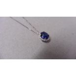 0.80ct halo set diamond pendant. Oval cut sapphire ( glass filled ) in the centre, 0.80ct, with a