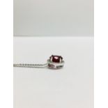 2.40ct halo set diamond pendant. Oval cut ruby ( glass filled ) in the centre, 2.40ct, with a halo