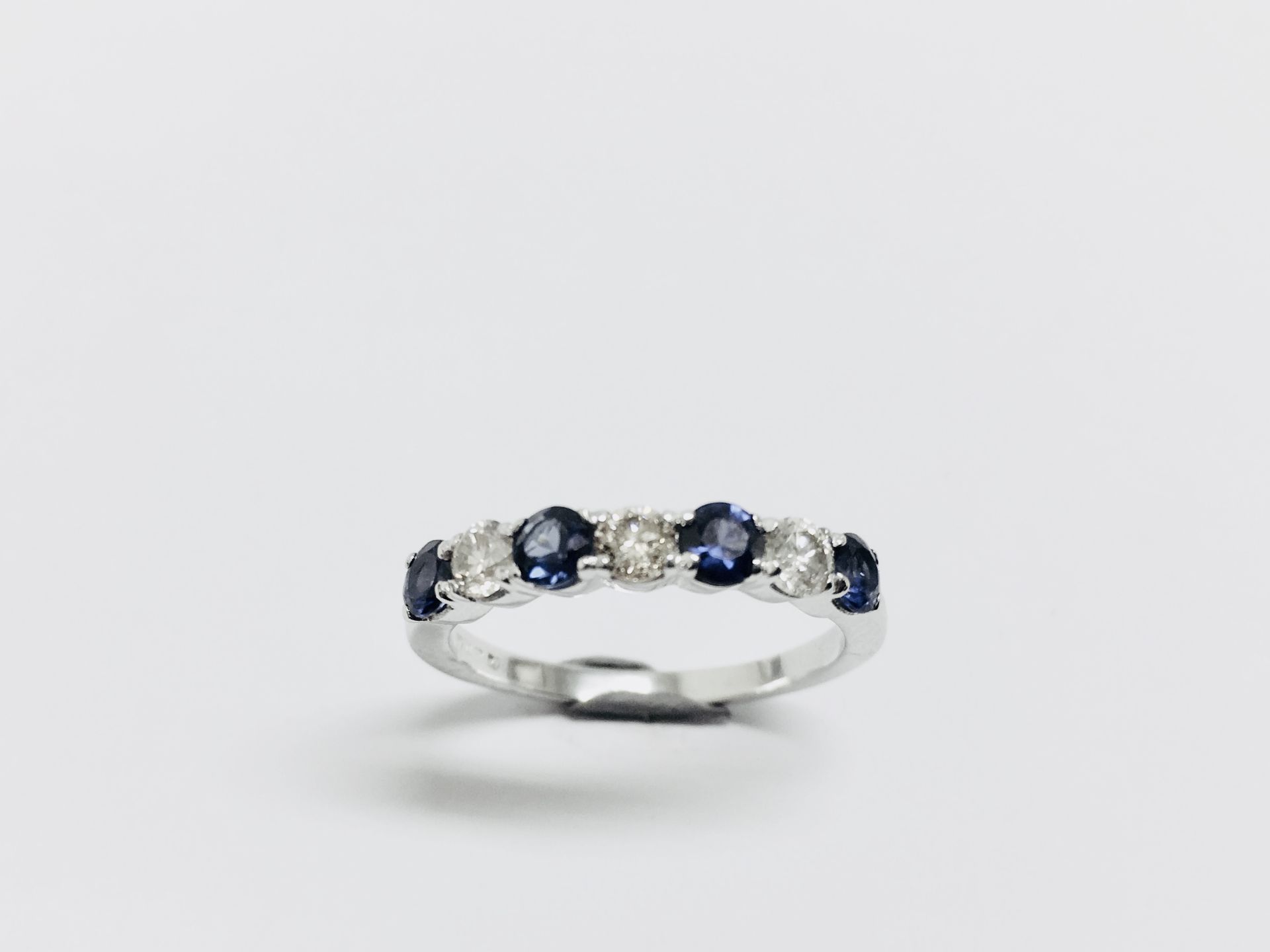 0.40ct sapphire and diamond eternity style ring. Set with 4 round cut sapphires and 3 diamonds. Size