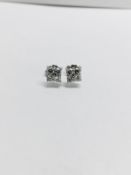 0.80ct dimond cluster style stud earrings. Each set with 4 small brillint cut diamonds, I colour and