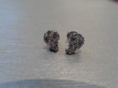 Pear shaped diamond earrings. Each is illusion set with small brilliant cut diamonds, weighing 0.