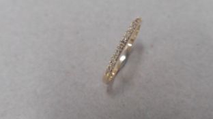 0.13ct diamond band ring set in 14ct yellow gold. Small brilliant cut diamonds, I colour and i1